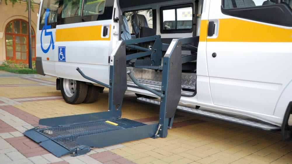 NEMT Contracts and Waivers of Subrogation. Wheelchair van with lift extended.