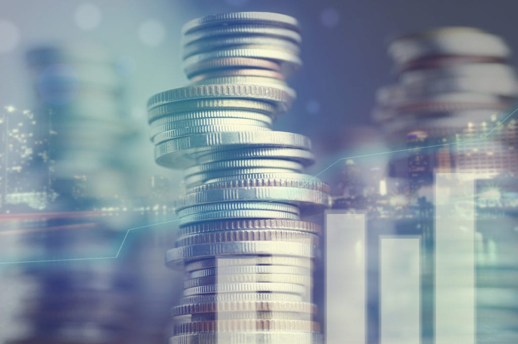 Financial institutions insurance liability, a stack of coins overlaid with a cityscape and graph.