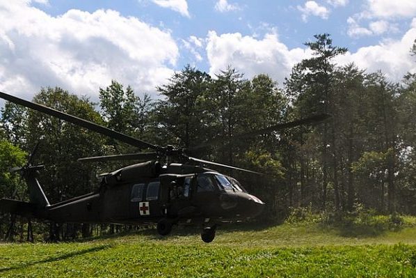 Bowling Green, VA insurance agency, Army medevac helicopter landing on green field at Fort AP Hill.