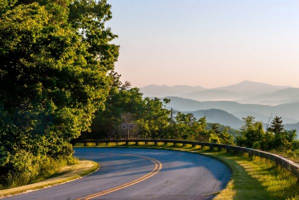 Asheville, NC Insurance Agency, a curve on the Blue Ridge Parkway overlooking scenic green mountains in the distance.