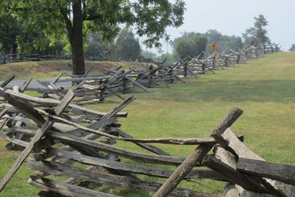 Fairfax, VA Manassas Battlefield, long line of split rail fence surrounding green battlefield lawns.