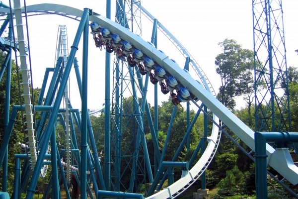 Newport News, VA Busch Gardens blue roller coaster suspended below metal tracks, zipping by in motion blur.
