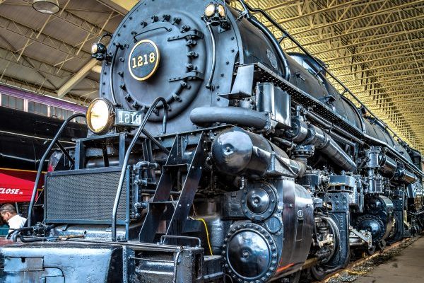 Roanoke, VA huge black steam locomotive beneath metal trussed canopy in the Virginia Museum of Transportation.