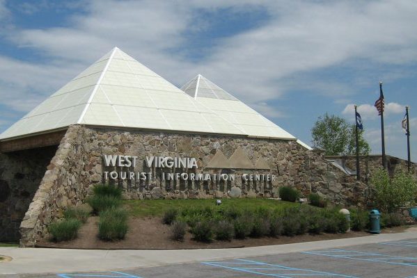 West Virginia tourist welcome center, pyramid-shaped brown granite stone walls with aluminum and glass peaks.