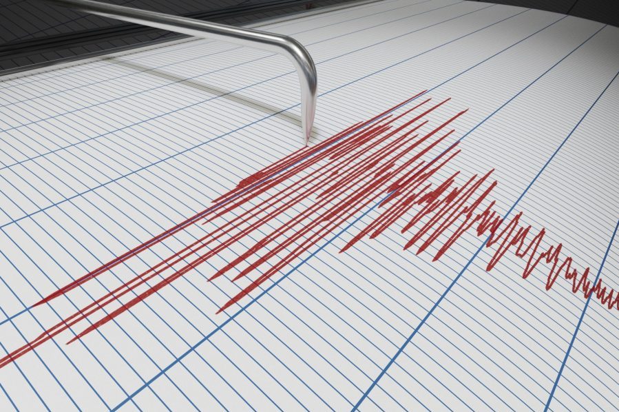 Seismograph showing red lines are blue lined paper.