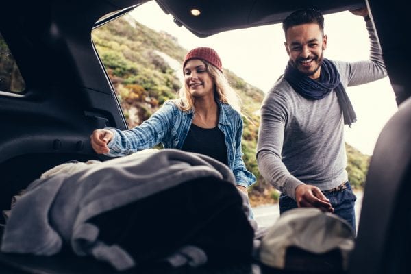 Happy couple covered by rental car insurance