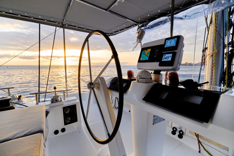 Sunset view through sailboat cabin full of navigation accessories.